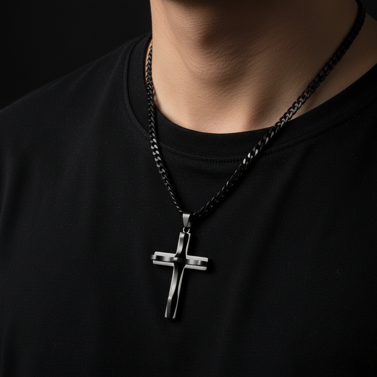 Black cross necklace on dark background - no face