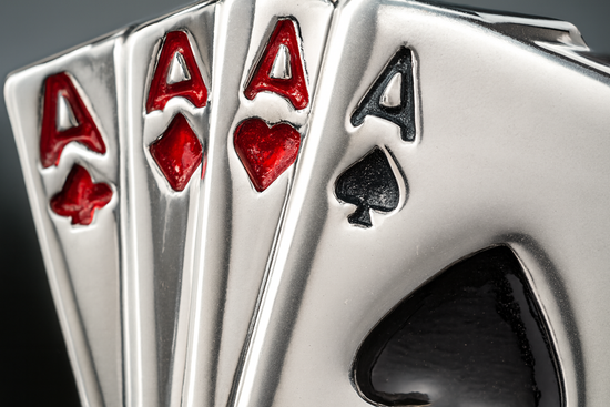Extreme close-up detail of playing card cufflinks showing four aces craftsmanship