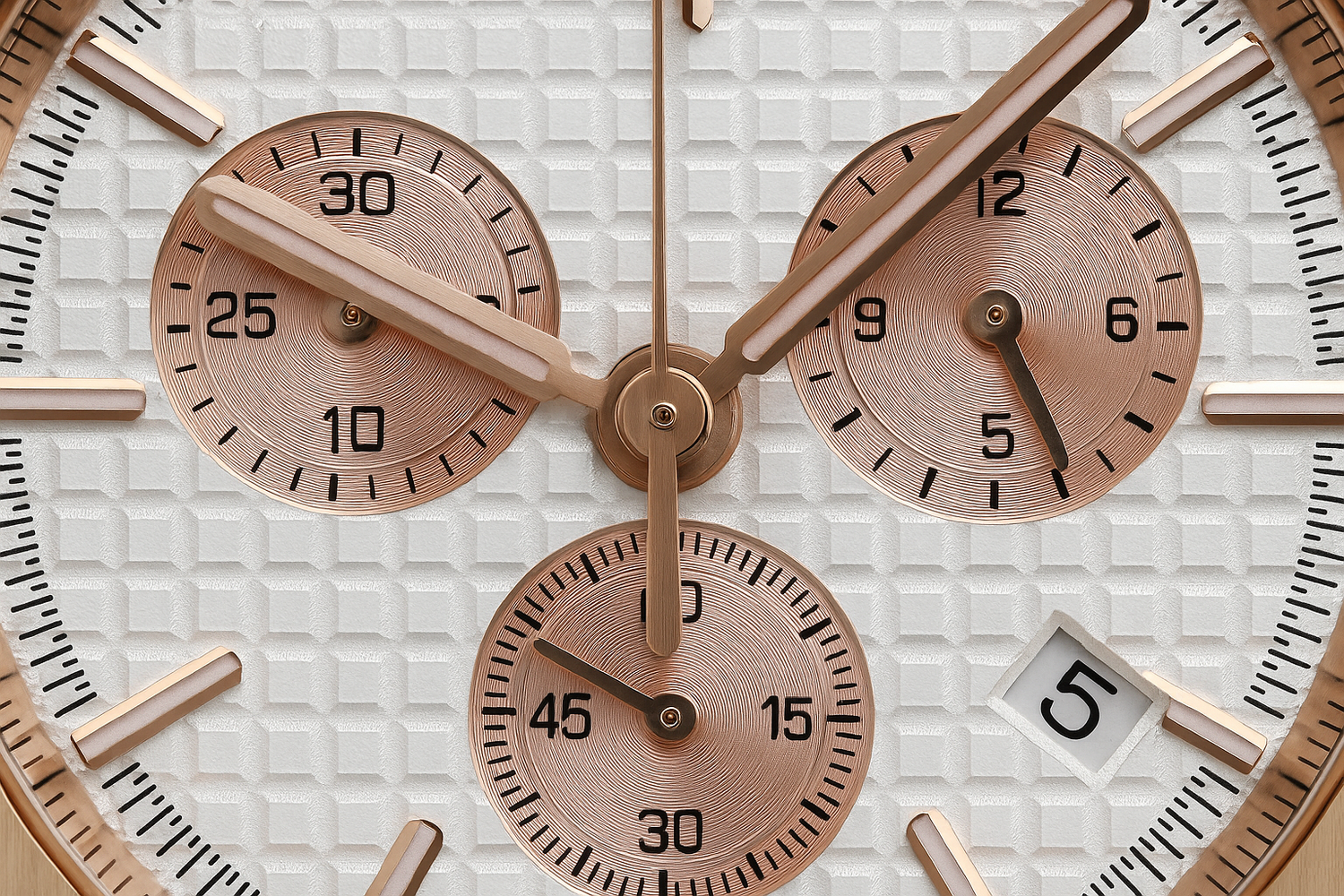 Extreme close-up of pinkish rose gold watch with detailed dial
