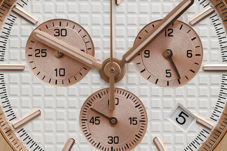 Extreme close-up of pinkish rose gold watch with detailed dial