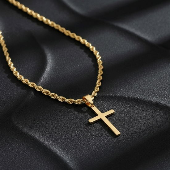 Gold cross necklace close-up with dark charcoal background