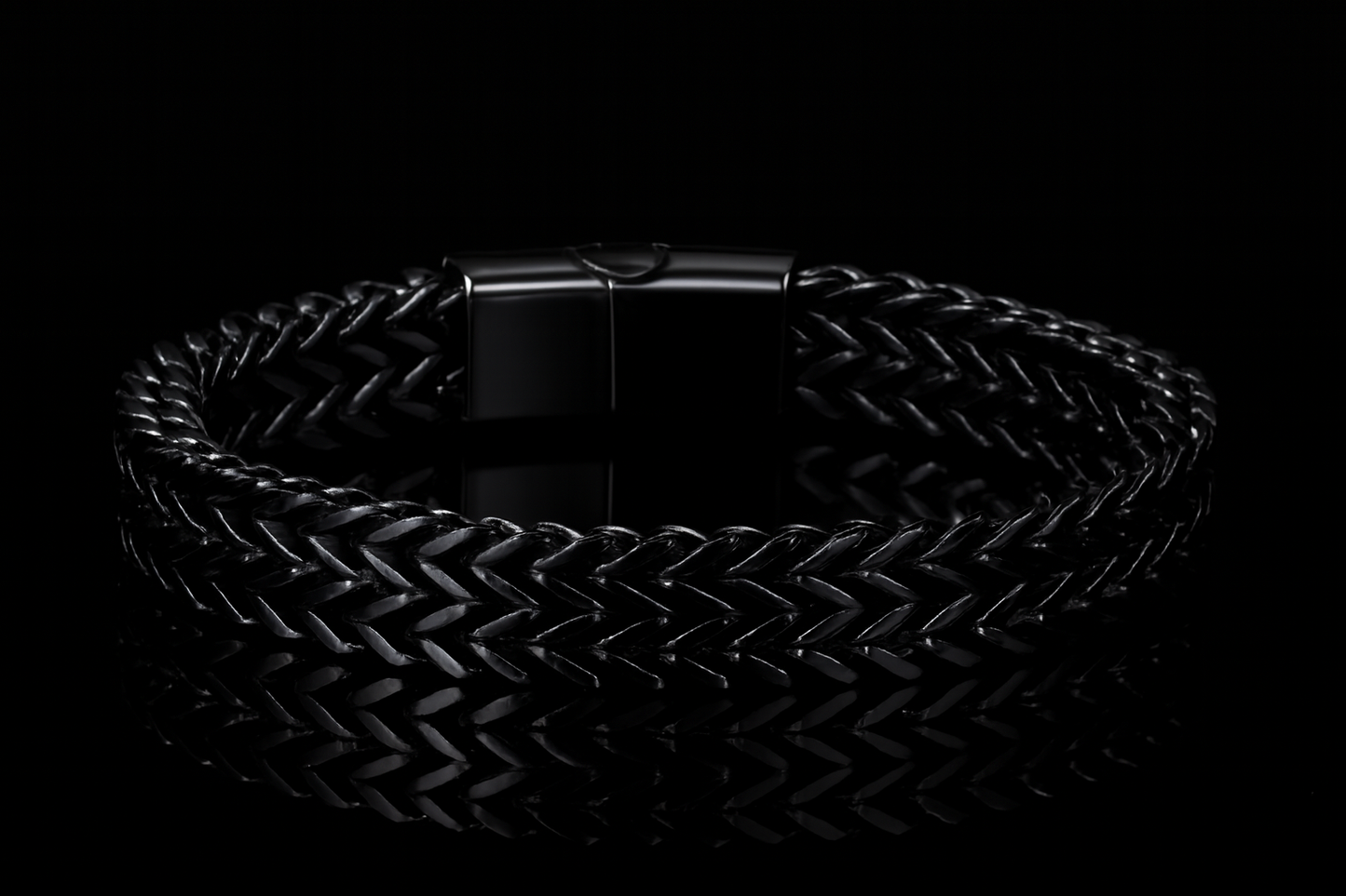 Multiple angles of the shiny black bracelet on black table