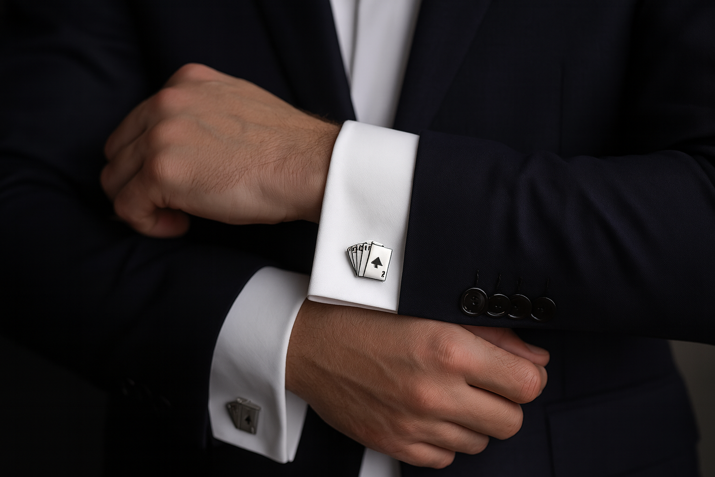 Playing card cufflinks on navy suit with white dress shirt