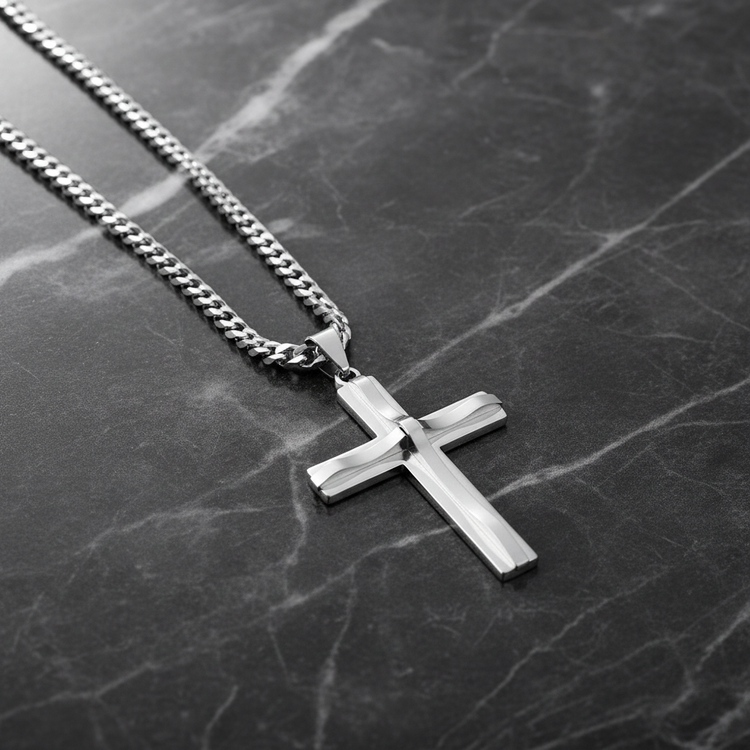 Silver cross necklace on dark marble
