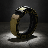 Artistic shot of tan tactical belt on weathered surface