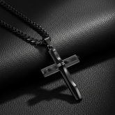 Black cross necklace on black leather