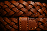 Close-up detail of brown braided leather belt