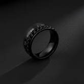 Close-up of black Roman numeral ring