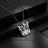 Close-up of Decepticon necklace with dark geometric background