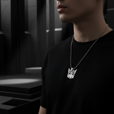 Decepticon necklace being worn with dark geometric background