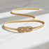 Elegant flat lay of gold chain belt on marble surface