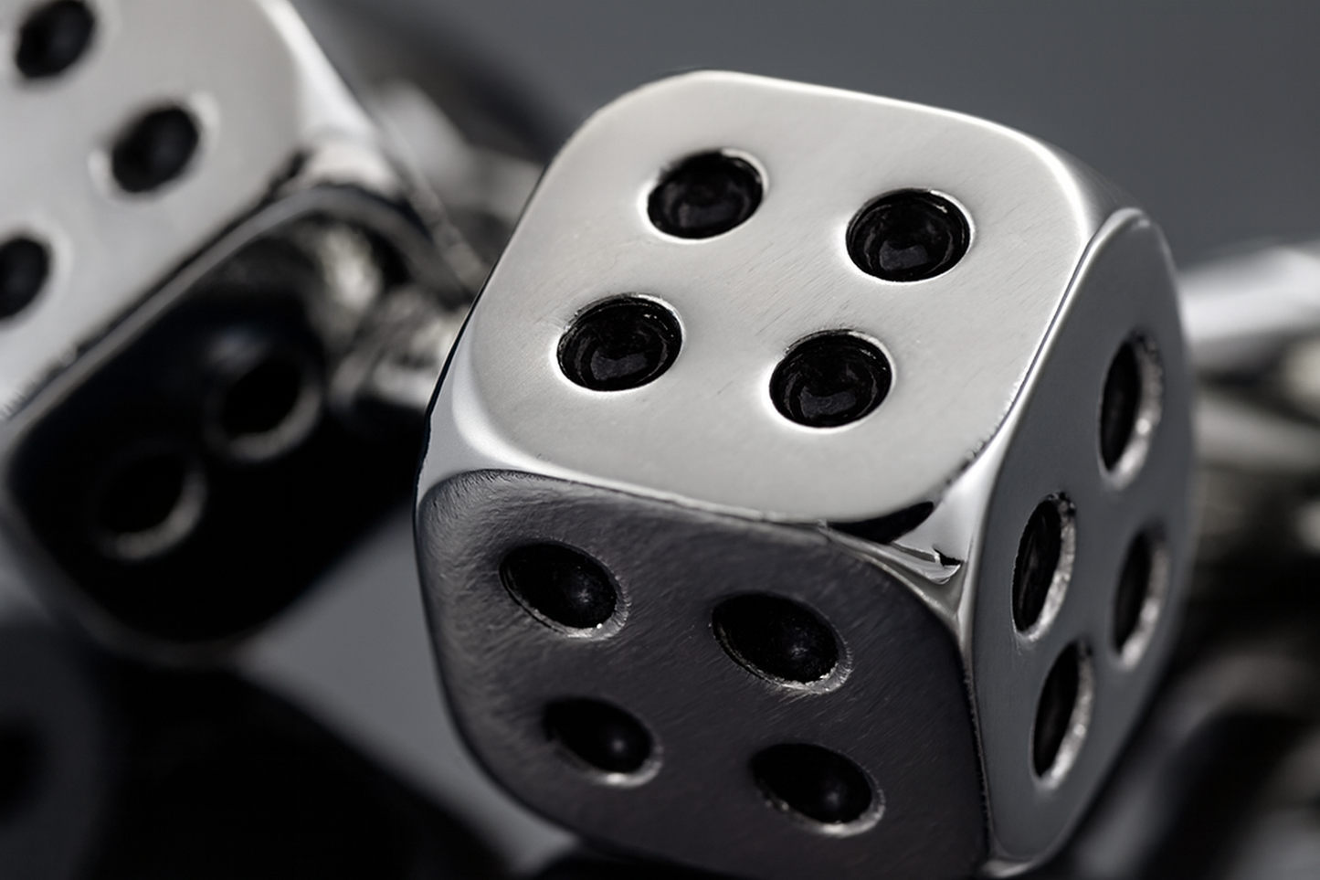 Extreme close-up of silver dice cufflinks showing premium craftsmanship and detail