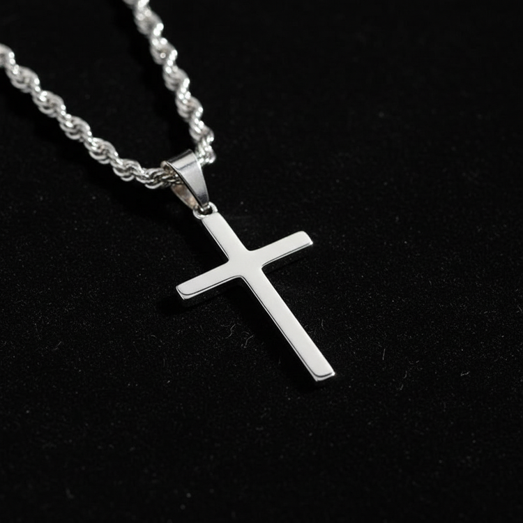 Extreme macro shot of silver cross pendant with black velvet background