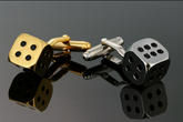Gold and silver dice cufflinks together in elegant composition