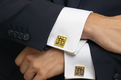 Gold "BUY LOW" trading cufflinks on navy suit