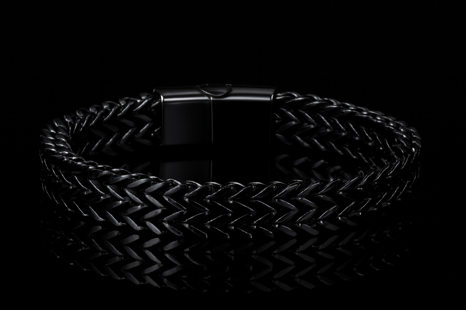 Multiple angles of the shiny black bracelet on black table