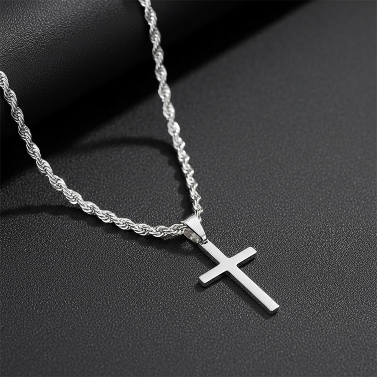 Silver rope chain necklace with cross pendant on dark background
