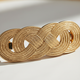 Super close-up macro shot of the gold chain belt buckle details