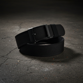 Tactical belt on dark textured concrete surface