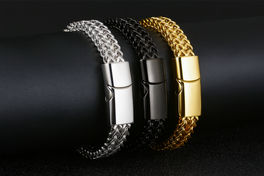 Three double chevron chain bracelets - silver, black, and gold with refined proportions